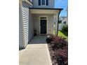 Exterior entrance showcasing the front door and small, landscaped garden in front at 99 Still Hand Dr, Clayton, NC 27527