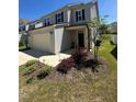 View of the home's exterior showcasing the attached garage and newly landscaped yard at 99 Still Hand Dr, Clayton, NC 27527