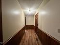 Inviting hallway with wood trim and durable wood flooring leading to various rooms at 1012 Bermuda Run, Knightdale, NC 27545