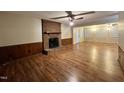 Spacious living room featuring a brick fireplace and wood floors, perfect for gatherings at 1012 Bermuda Run, Knightdale, NC 27545