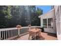 Spacious deck with table and chairs, perfect for outdoor dining and relaxation in a private setting at 104 Edgewater Cir, Chapel Hill, NC 27516
