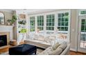 Sun-filled living room with built-in shelving, fireplace and large windows overlooking the outdoors at 104 Edgewater Cir, Chapel Hill, NC 27516
