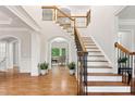 Grand foyer features hardwood floors, an elegant staircase, and arched doorways at 119 Eagles Watch Ln, Chapel Hill, NC 27517