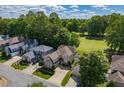 Aerial view of a home situated in a neighborhood with lush green trees and golf course views at 121 Walter Hagen Dr, Mebane, NC 27302