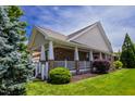 Charming single-story home featuring a welcoming brick porch with white columns and lush landscaping at 1218 Crystalwater Dr, Fuquay Varina, NC 27526