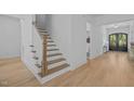 Bright entryway featuring a wood staircase with white risers and wood floors at 1338 The Parks Dr, Pittsboro, NC 27312