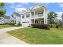 Gorgeous two-story home with a two car garage, a welcoming front porch, and well-maintained landscaping at 145 Cassada Ct, Holly Springs, NC 27540