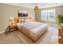 Staged main bedroom featuring a large window with a queen size bed and nightstands at 1517 Chestnut Falls Rd, Wendell, NC 27591