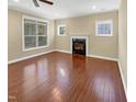 Unstaged living room with fireplace, hardwood floors, and bright natural light at 1517 Chestnut Falls Rd, Wendell, NC 27591