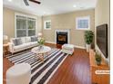 Staged living room with fireplace, hardwood floors, and bright natural light at 1517 Chestnut Falls Rd, Wendell, NC 27591