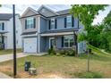 Charming two-story home with a manicured lawn and attached garage at 173 Forsyth Pkwy Pkwy, Clayton, NC 27520