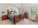 Comfortable bedroom featuring a ceiling fan, plush carpeting, and a cozy sitting area near the window at 227 Kenmont Dr, Holly Springs, NC 27540