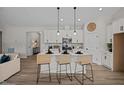 Modern kitchen featuring an island with barstool seating and white cabinets with an eat-in area at 260 Pretty Run Branch Ln, Wendell, NC 27591