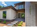 Elegant home entrance showcasing a modern exterior with brick accents, stepping stone pathway, and well-maintained landscaping at 2805 Van Dyke Ave, Raleigh, NC 27607