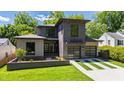 Modern home with a gray brick and siding facade, two-car garage, manicured lawn, and a landscaped front yard at 2805 Van Dyke Ave, Raleigh, NC 27607
