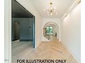 Bright foyer with herringbone wood floors, a modern chandelier, and an arched entryway at 3422 Redbud Ln, Raleigh, NC 27607