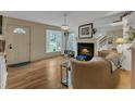 Inviting living room with a fireplace, hardwood floors and lots of natural light coming through a bay window at 4009 Olde Coach Rd, Durham, NC 27707