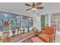 Bright sunroom with wood-look flooring and lots of natural light coming in from the large windows at 4009 Olde Coach Rd, Durham, NC 27707