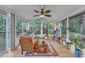 Bright sunroom with wrap around windows provides a tranquil space to relax and enjoy the surrounding nature at 4009 Olde Coach Rd, Durham, NC 27707