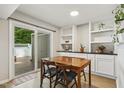 Cozy dining area featuring a table for four, built-in shelving, and sliding door access at 4645 Edwards Mill Rd, Raleigh, NC 27612