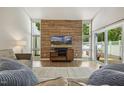 Bright living room with wood accent wall, hard floors and sliding door access to the exterior at 4645 Edwards Mill Rd, Raleigh, NC 27612