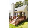 Exterior shot of a back deck featuring stairs, railing, and a covered area at 4905 Knightsbridge Way, Raleigh, NC 27604
