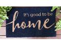 Close-up of a welcome mat that reads 
