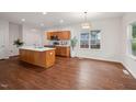Spacious kitchen with wood cabinets, stainless steel appliances, and an island with a sink at 507 N Elm St, Durham, NC 27701
