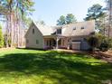 Spacious backyard with a covered patio, perfect for outdoor entertaining and relaxation at 5401 Fire Pink Way, Raleigh, NC 27613