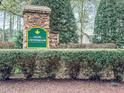 Stone community sign for Olde Creedmoor, surrounded by lush greenery and mature landscaping at 5401 Fire Pink Way, Raleigh, NC 27613
