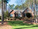 Beautiful brick home with mature trees, lush lawn, and meticulous landscaping for curb appeal at 5401 Fire Pink Way, Raleigh, NC 27613