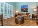 Cozy living room with hardwood floors, plantation shutters, and stylish decor at 5401 Fire Pink Way, Raleigh, NC 27613