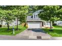 Charming home featuring a two-car garage, stone accents, and a well-manicured lawn at 6 Beaver Creek Lane Ln, Durham, NC 27703