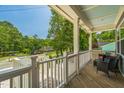 Inviting covered porch with comfortable seating, offering a view of the street and surrounding greenery at 647 N Hardee St, Durham, NC 27703