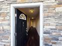 Inviting entryway features a stone accent wall, and dark hardwood floors and leads into a spacious hallway at 650 Ganyard Farm Way # 41, Durham, NC 27703