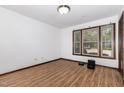 Bright bedroom features wood-look flooring, a large window, and neutral walls at 6516 Hearthstone Dr # 6516, Raleigh, NC 27615