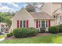 A well-maintained home with neat landscaping is accented by striking red shutters on the front windows at 6516 Hearthstone Dr # 6516, Raleigh, NC 27615