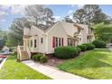 Charming townhome featuring red shutters and lush landscaping in a well-maintained community at 6516 Hearthstone Dr # 6516, Raleigh, NC 27615