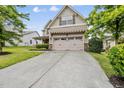 Charming two-story home with a two car garage and a well maintained lawn at 817 Ember Dr, Durham, NC 27703