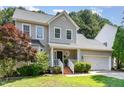 Charming two-story home boasts a well-maintained lawn, attached garage, and beautiful landscaping at 8512 Erinsbrook Dr, Raleigh, NC 27617