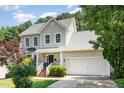 Charming two-story home boasts a well-maintained lawn, attached garage, and beautiful landscaping at 8512 Erinsbrook Dr, Raleigh, NC 27617