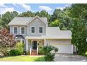 Charming two-story home boasts a well-maintained lawn, attached garage, and beautiful landscaping at 8512 Erinsbrook Dr, Raleigh, NC 27617