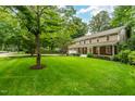 Desirable home featuring a well-manicured lawn, mature trees, and an inviting front porch at 8608 Valley Brook Dr, Raleigh, NC 27613