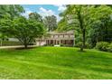 Beautiful home featuring a sprawling front lawn and mature trees providing ample shade and curb appeal at 8608 Valley Brook Dr, Raleigh, NC 27613