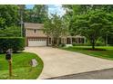 Attractive home featuring a long driveway, a two-car garage, and an inviting front porch at 8608 Valley Brook Dr, Raleigh, NC 27613