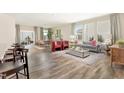 Spacious living room open to dining area, showcasing hardwood floors and abundant natural light at 904 Emmer St, Rolesville, NC 27571