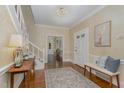Inviting foyer with hardwood floors, a patterned rug, and a view into other rooms at 938 Hargrove St, Henderson, NC 27536