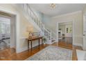 A charming foyer with hardwood floors and staircase showcasing the home's traditional style at 938 Hargrove St, Henderson, NC 27536
