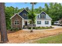 Inviting home with a covered porch, stone details, and a well-maintained yard at 100 Lexington Ave, Zebulon, NC 27597