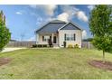 Attractive home featuring a well-maintained lawn, complemented by mature trees at 1071 Turlington Rd, Dunn, NC 28334